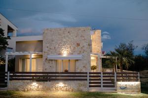 a house with lights on the front of it at casale in Nikiti