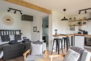 a living room and kitchen with a bed and chairs at The Jolly Lodge-Sea Views-Free Parking in Lyme Regis