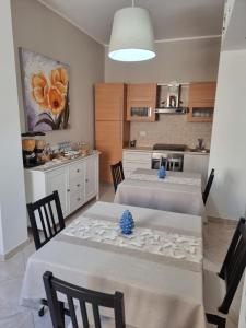 a kitchen with two tables with chairs and a kitchen with a tableablish at Bed and Breakfast Federica in Noto +13 photos