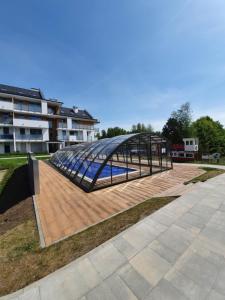 a metal structure on top of a wooden deck at MIERZEJA PARK 13B in Sztutowo