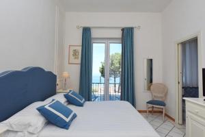 Postel nebo postele na pokoji v ubytování Hotel Garden Riviera