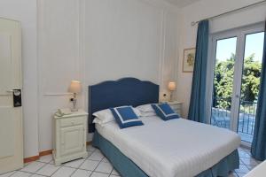 Postel nebo postele na pokoji v ubytování Hotel Garden Riviera