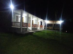 a house lit up at night with two street lights at Buni Shqipes in Theth