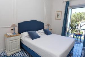 Postel nebo postele na pokoji v ubytování Hotel Garden Riviera