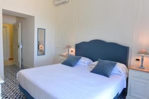 Postel nebo postele na pokoji v ubytování Hotel Garden Riviera