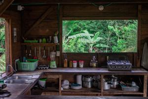 a kitchen with a sink and a window at The Pelican House Hostel in El Valle