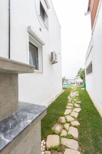 a stone walkway between two buildings with a window at Summer Private Villa with Garden and Private Pool, Within Walking Distance to the Sea in Bodrum Gumusluk in Bodrum City