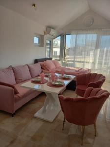 a living room with a couch and a table with chairs at Perla 2 studio in Burgas City +12 photos