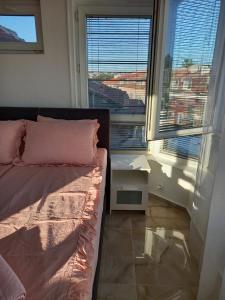 a bedroom with a bed and a large window at Perla 2 studio in Burgas City
