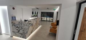 a lobby with a counter and chairs in a building at Elarin studios & apartments in Faliraki