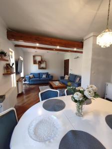 a living room with a white table and blue couch at Deluxe Apartment Lejla - Free garage parking in Sarajevo