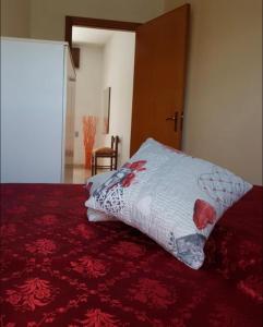 a bed with a pillow sitting on top of it at Gallipoli Mancaversa Futura Vacanza Andrea in Marina di Mancaversa