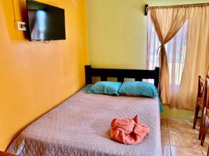 a bedroom with a bed with a towel on it at Apartamentos M&M in Fortuna