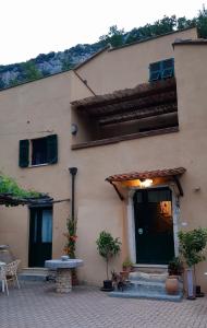 a building with a table and a bench in front of it at Agriturismo Alveare in Finale Ligure