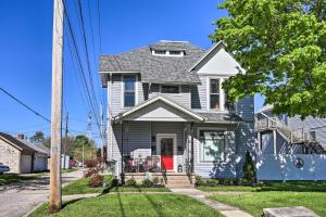 a white house with a red door at Port Clinton Getaway - Walk to Beach and Restaurants in Port Clinton