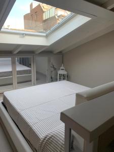 a bedroom with a bed and a skylight at HOUSE Cavour 24 In the heart of Downtown Parma in Parma