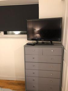 a tv sitting on top of a dresser at Exclusive Modern decorated 1 Bedroom Detached Studio in Newport