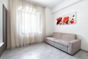 a living room with a couch and a window at Giselle Apartments Maiori - Amalfi Coast in Maiori