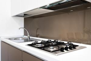 a kitchen with a stove and a sink at Giselle Apartments Maiori - Amalfi Coast in Maiori +31 photos