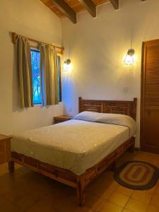 a bedroom with a bed and a window at Villas Tequisquipan in Tequisquiapan