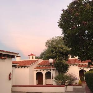 a white house with red tile roofs at Villas Tequisquipan in Tequisquiapan