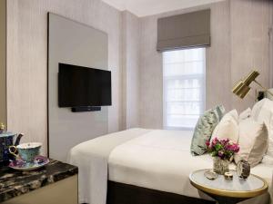 a hotel room with a bed and a tv at Fable Auckland, MGallery in Auckland