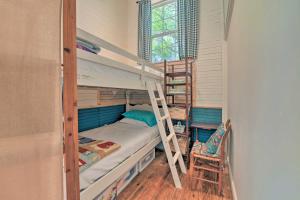 a bedroom with bunk beds with a ladder and a chair at Bright Converted Schoolhouse in Chesterfield! in Chesterfield