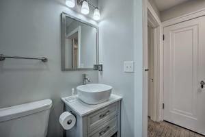 a white bathroom with a sink and a mirror at Benton Harbor Gracie Cottage with Hot Tub and Yard! in Benton Harbor +21 photos