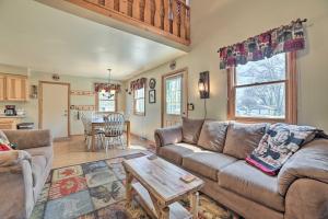 a living room with a couch and a table at Family Cottage 3 Mi to Higgins Lake State Pk! in Roscommon