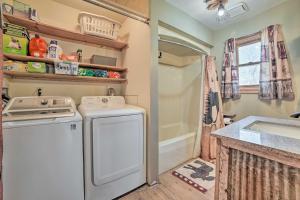 a kitchen with a washing machine and a sink at Family Cottage 3 Mi to Higgins Lake State Pk! in Roscommon +18 photos