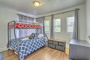 a bedroom with a bunk bed with a blue comforter at Beautiful Miami Getaway Less Than 6 Mi to Downtown! in Miami