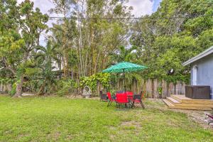 a patio with a table and chairs and an umbrella at Beautiful Miami Getaway Less Than 6 Mi to Downtown! in Miami