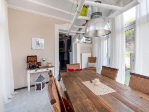 a dining room with a wooden table and chairs at Large holiday home in Mimbach with private garden in Ditscheid
