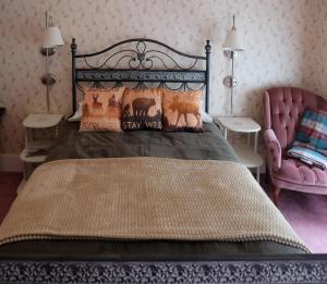 a bedroom with a large bed and a chair at Guilford Bed and Breakfast in Guilford