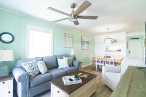 a living room with a couch and a table at Beach Harbour 16 @ The Carolina Beach Boardwalk - Full Remodel! in Carolina Beach
