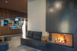a living room filled with furniture and a fire place at wellnessHostel4000 in Saas-Fee