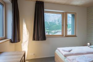 Postel nebo postele na pokoji v ubytování Saas-Fee wellnesshostel4000