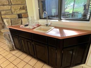 a kitchen counter with a sink and a window at Greens One Vacation Home 1 in Bella Vista +17 photos