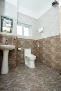 a bathroom with a toilet and a sink at Gauri Shankar Hotel Nagarkot in Nagarkot