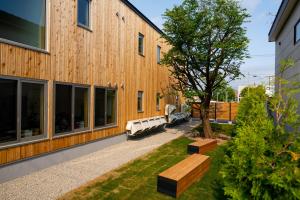 a building with benches and a tree next to it at Kamishihoro Hotel in Kami-shihoro