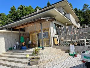 una casa con escaleras delante en 農家民宿　たなか, en Suzu
