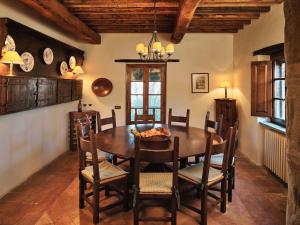 a dining room with a wooden table and chairs at Charming House in Umbria with Pool in Monte Castelli