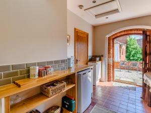 a kitchen with wooden shelves and a counter top at Barn End in Lincoln