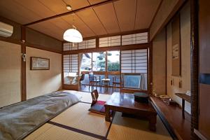 a room with a bed and a table in it at Yamada Bessou くつろぎの温泉宿 山田別荘 in Beppu +113 photos