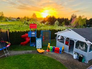 a backyard with a play set and a playground at Domki wczasowe OSKAR in Chłopy