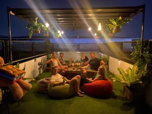a group of people sitting on bean bags in a room at Backpack Hostel in Chiang Rai
