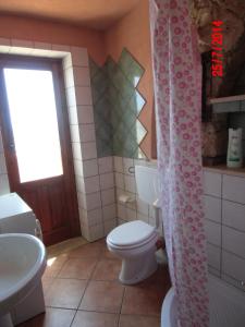 a bathroom with a toilet and a sink at Holiday home Santa Flavia in Santa Flavia