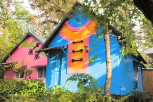 a house with a painting on the side of it at Tingtau Villa in Lugu Lake