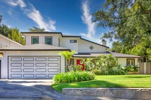 a white house with a garage at Tullis Charm in Los Angeles