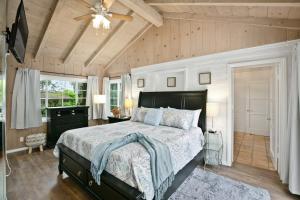 a bedroom with a bed and a ceiling fan at Ludington Haven in San Diego